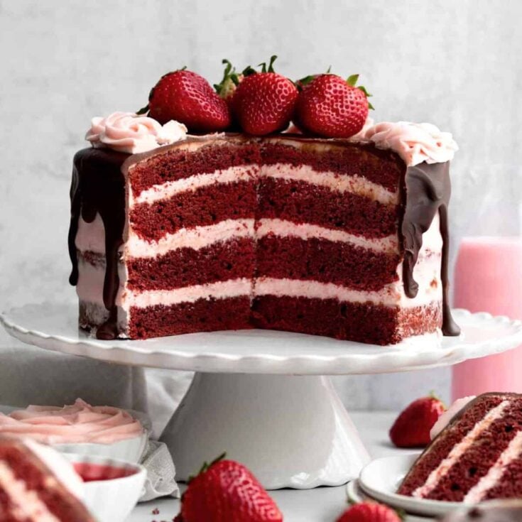 Sliced strawberry red velvet cake topped with strawberries