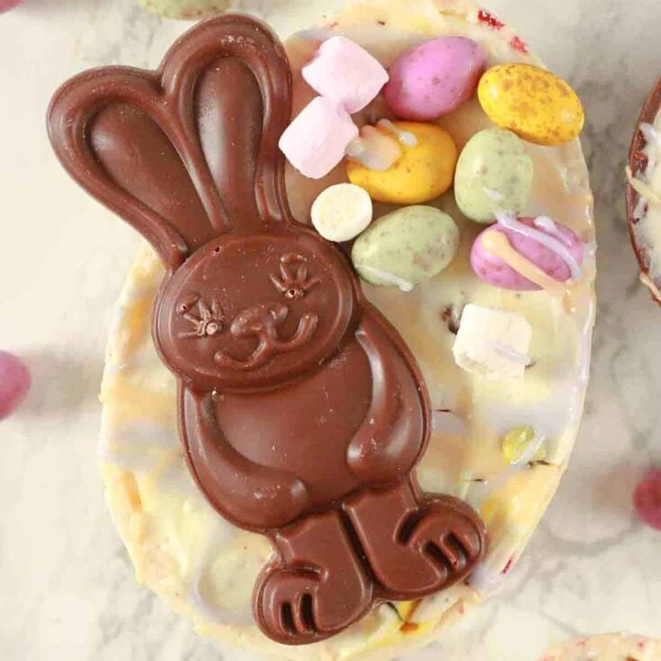 Vegan Easter egg cheesecake topped with little Easter eggs