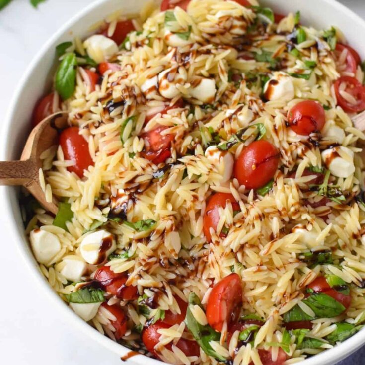 A bowl of Caprese orzo pasta salad