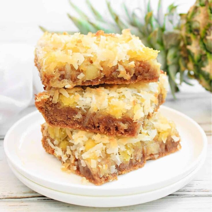 Three coconut pineapple bars on a plate