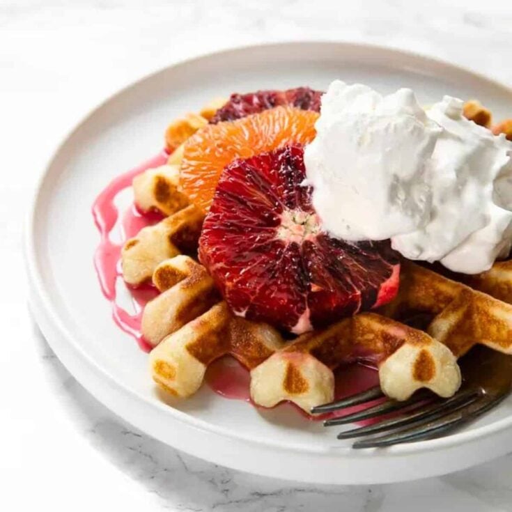Crispy waffles with blood orange glaze on a plate