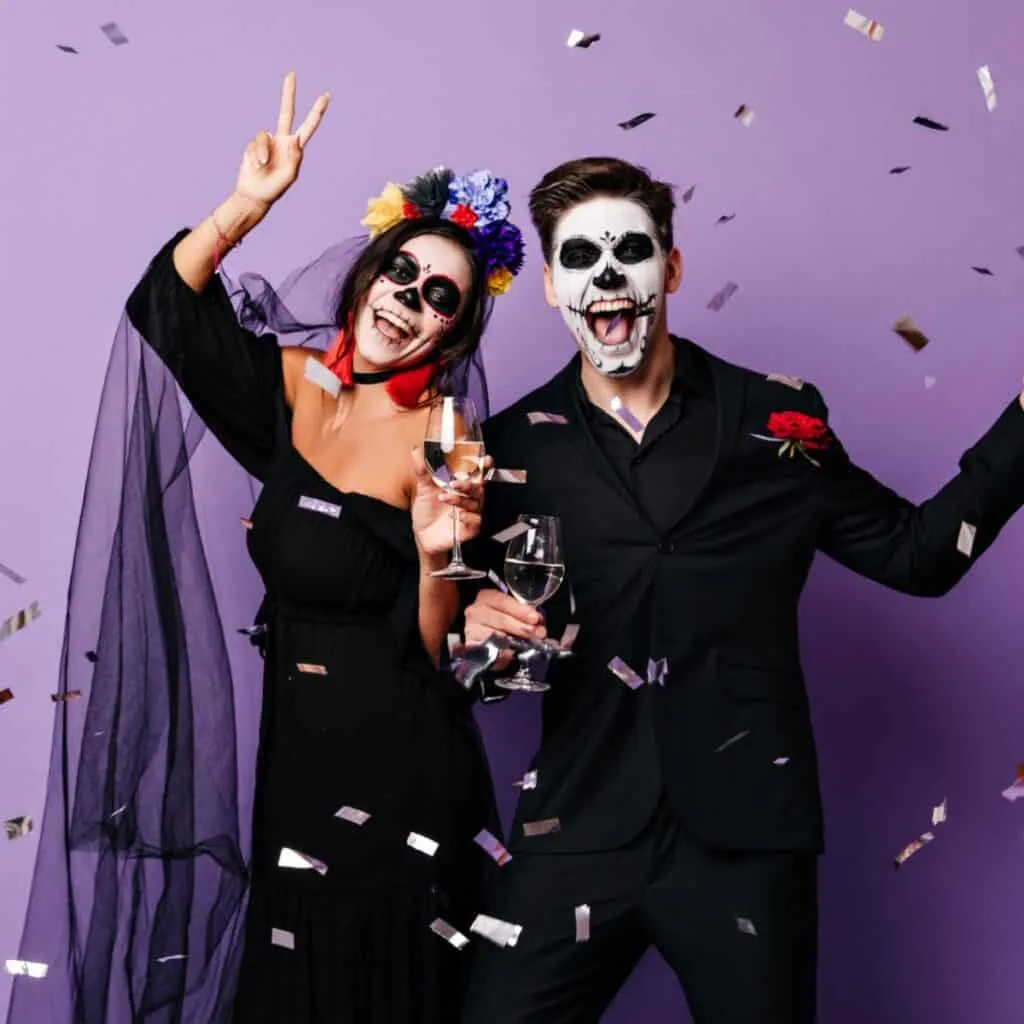 A purple background with a man and a woman in their Halloween costumes: Halloween would you rather