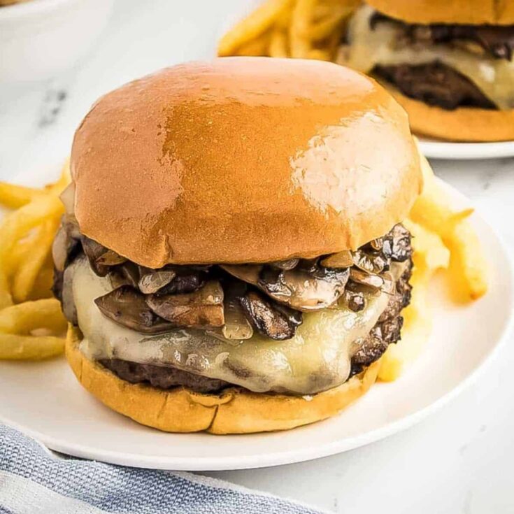 Mushroom Swiss burger with fries on the side