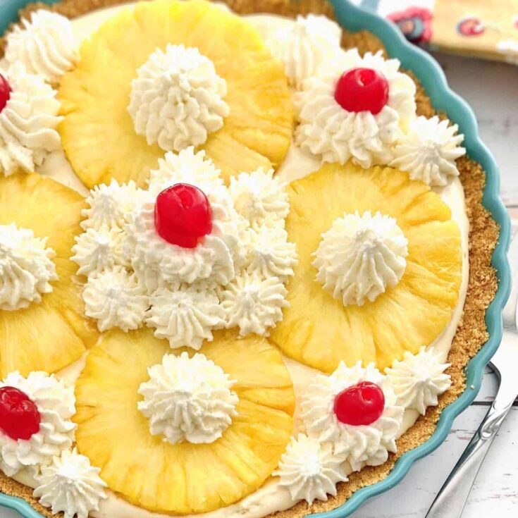 No bake pineapple pie topped with cherries and pineapple slices
