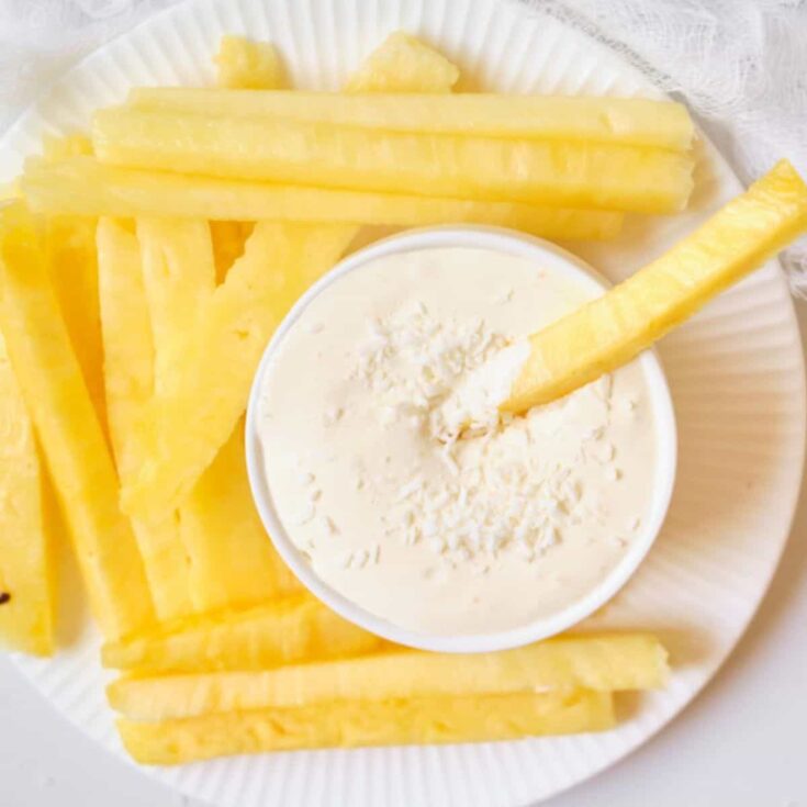 Pina colada fruit dip with sliced pineapples