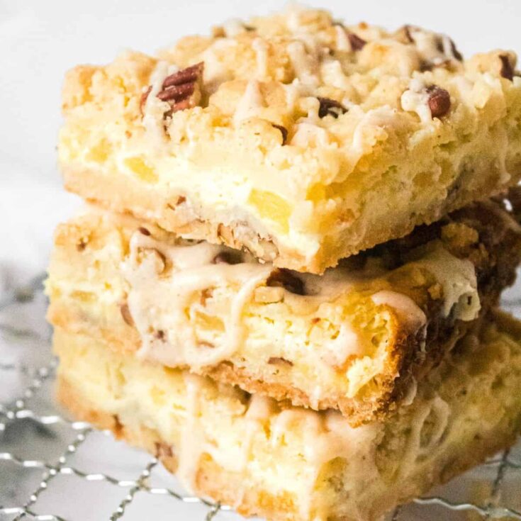 A stack of pineapple pecan cheesecake dessert bars
