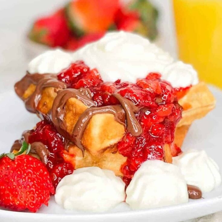 Strawberry shortcake waffles with Nutella on a plate