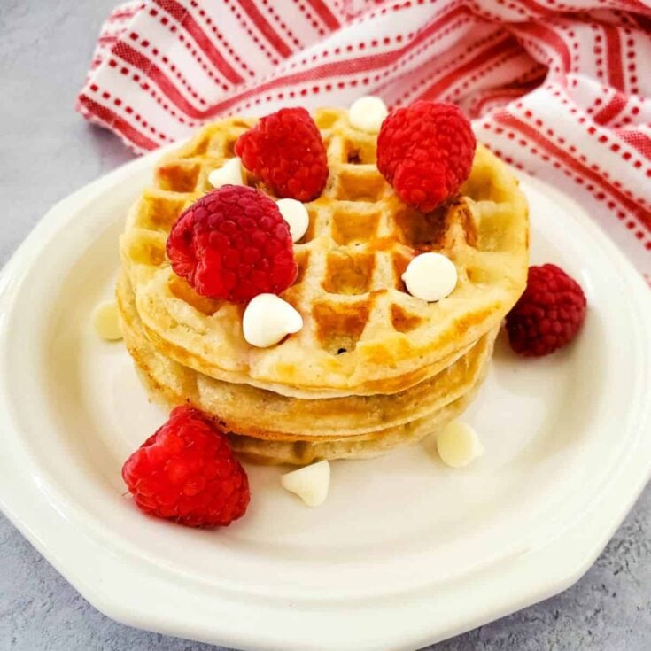 A plate of white chocolate and raspberry homemade waffles