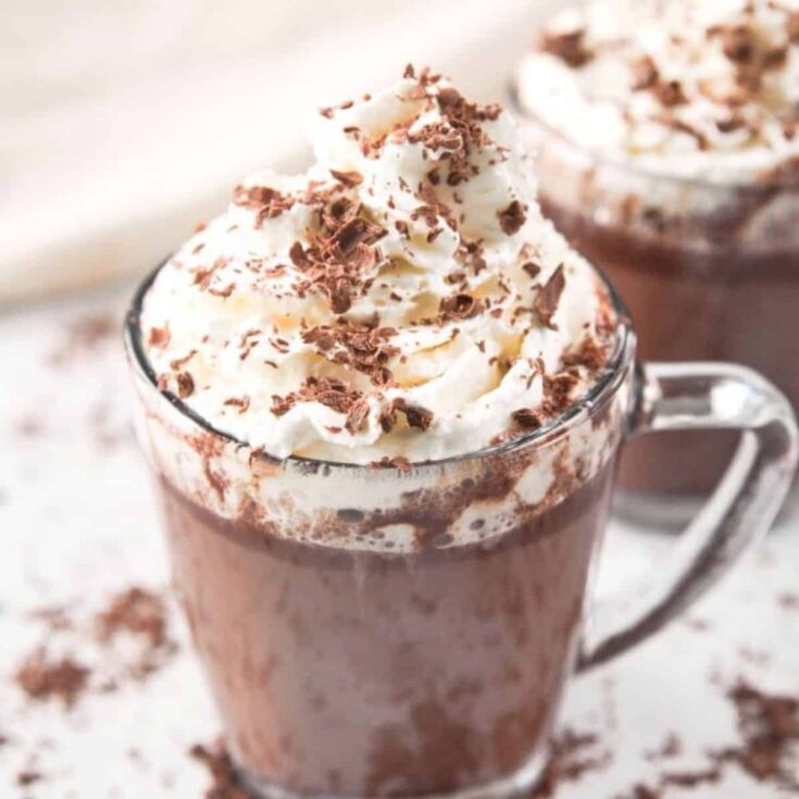 5-Ingredient Vegan hot chocolate topped with whipped cream and chocolate flakes