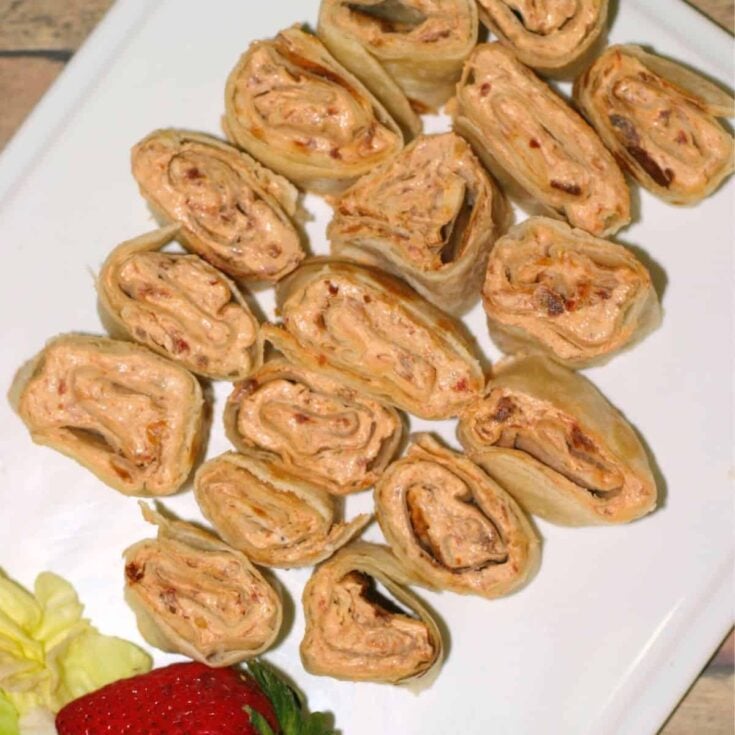 A plate of basil sun-dried tomato pinwheel
