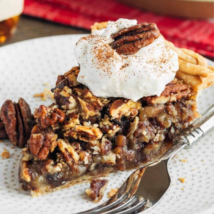A slice of chocolate pecan pie with bourbon