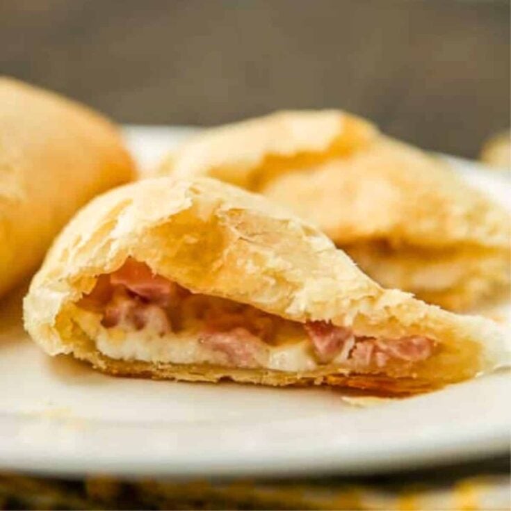 A plate of ham and cheese breakfast empanadas