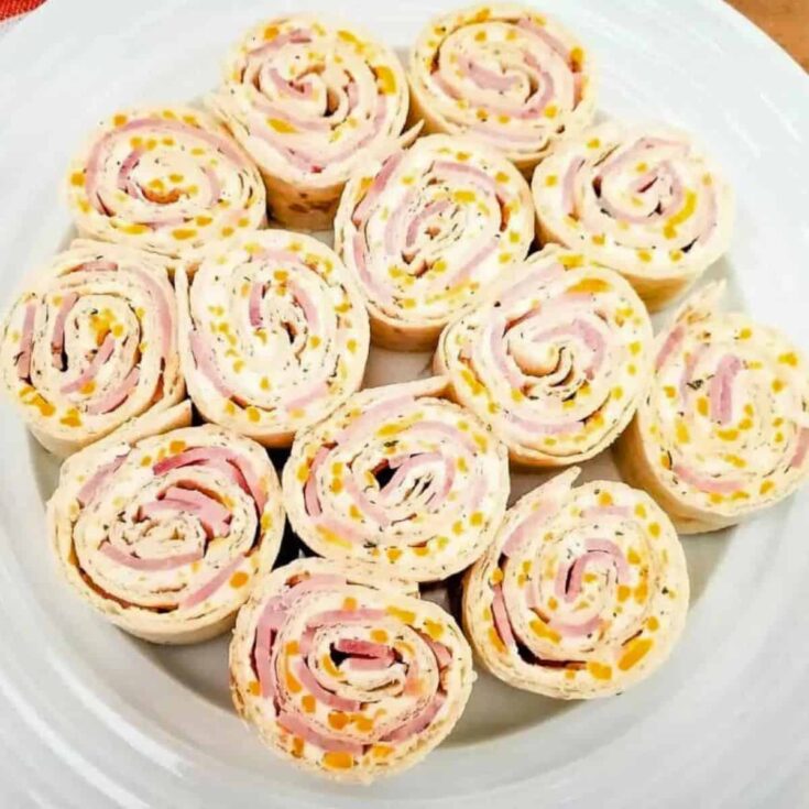 A plate of ham and cheese sandwich pinwheel