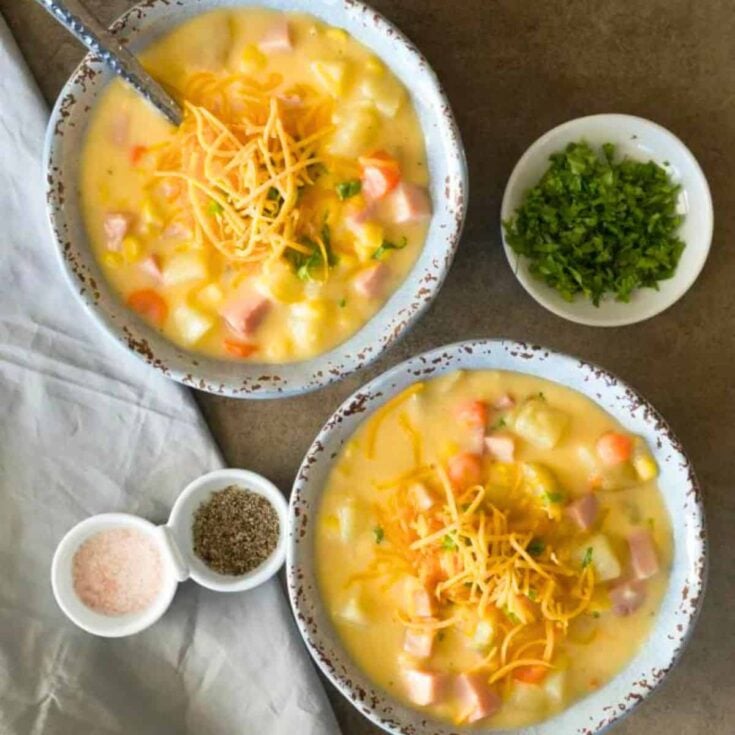 Two bowls of ham and potato chowder