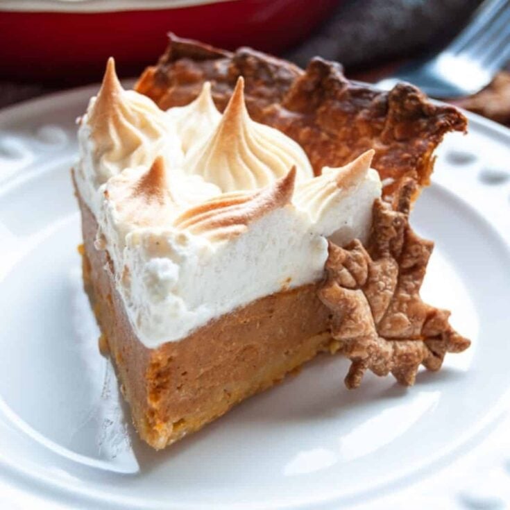 A slice of marshmallow meringue spiced rum pumpkin pie
