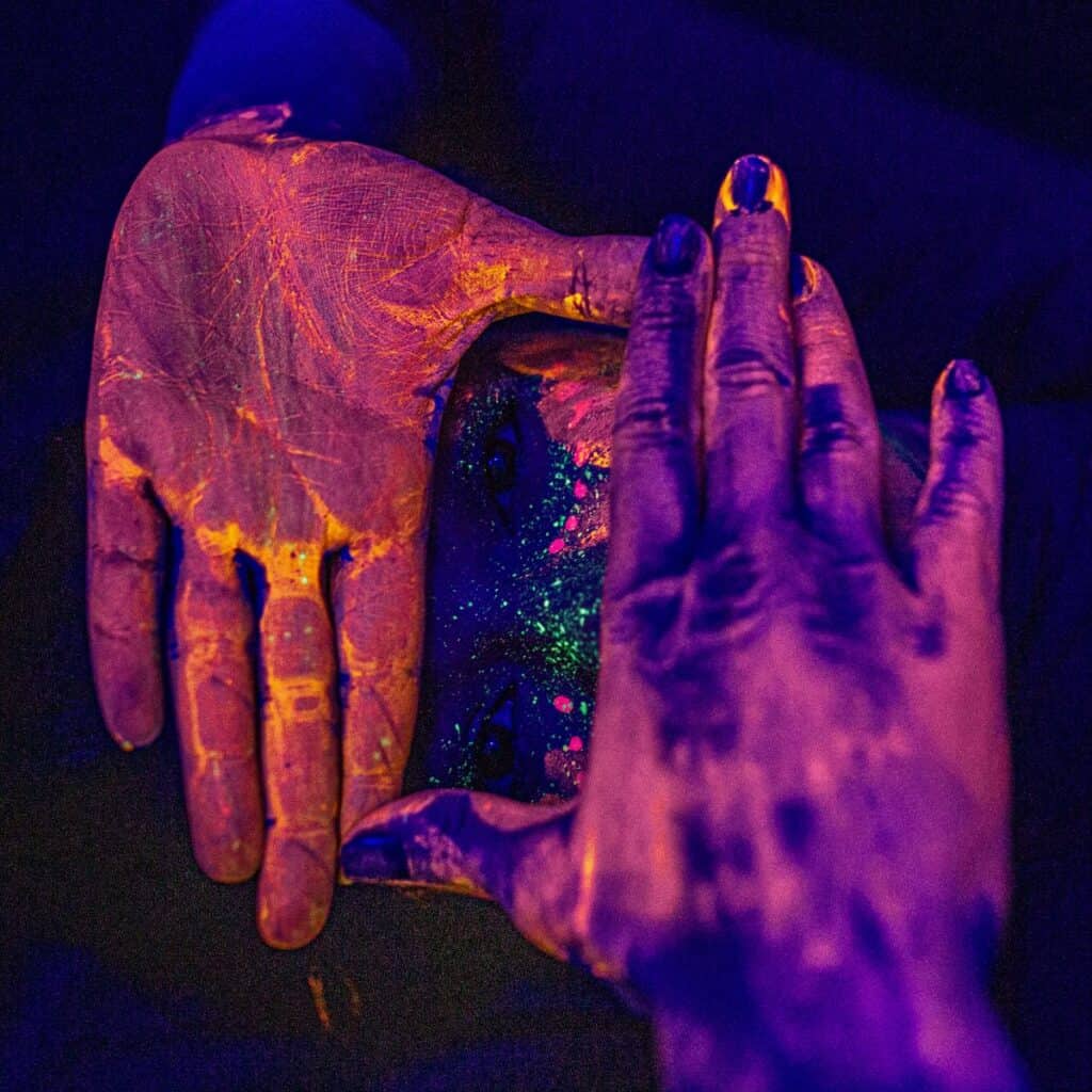 Hands with glow in the dark paint