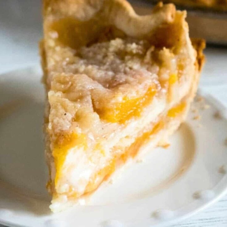 Peach crumble pie on a plate