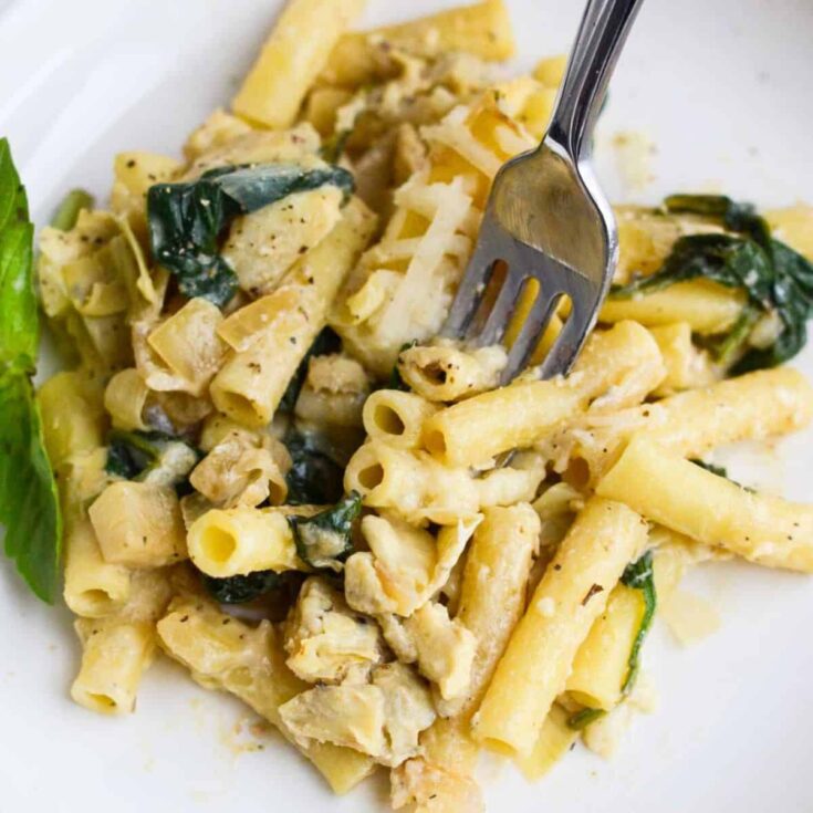 A plate of spinach and artichoke baked ziti