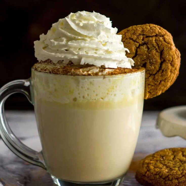 Chai white hot chocolate with a cookie and whipped cream