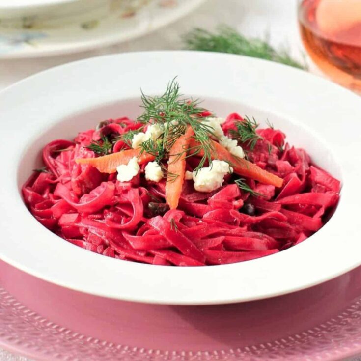 Fettuccine with beet smoked salmon and feta on a plate