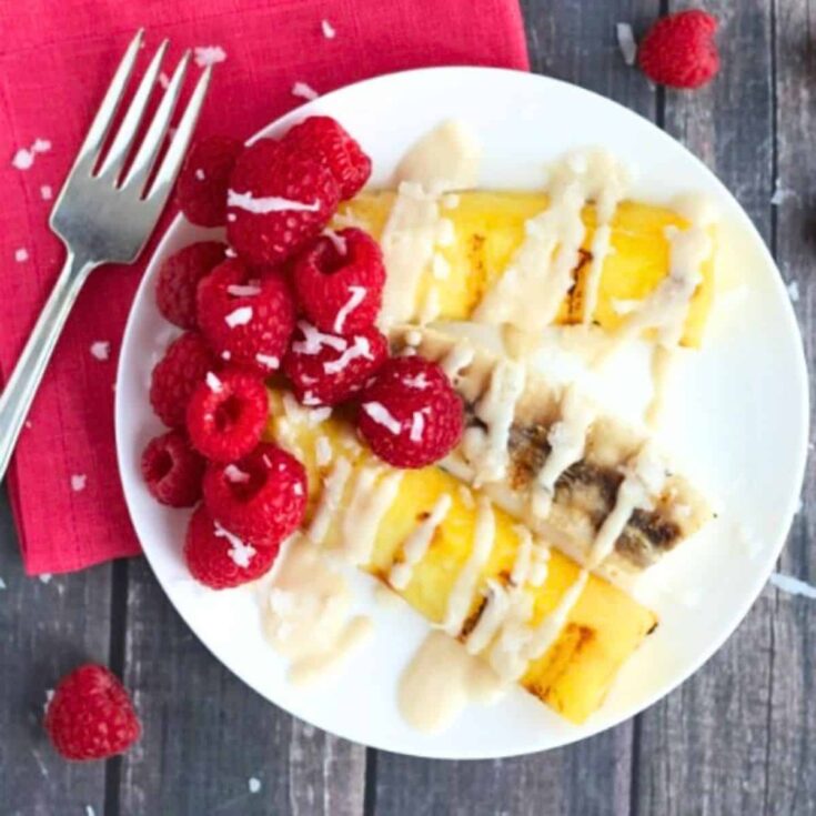 A plate of grilled tropical fruit with almond-ricotta sauce