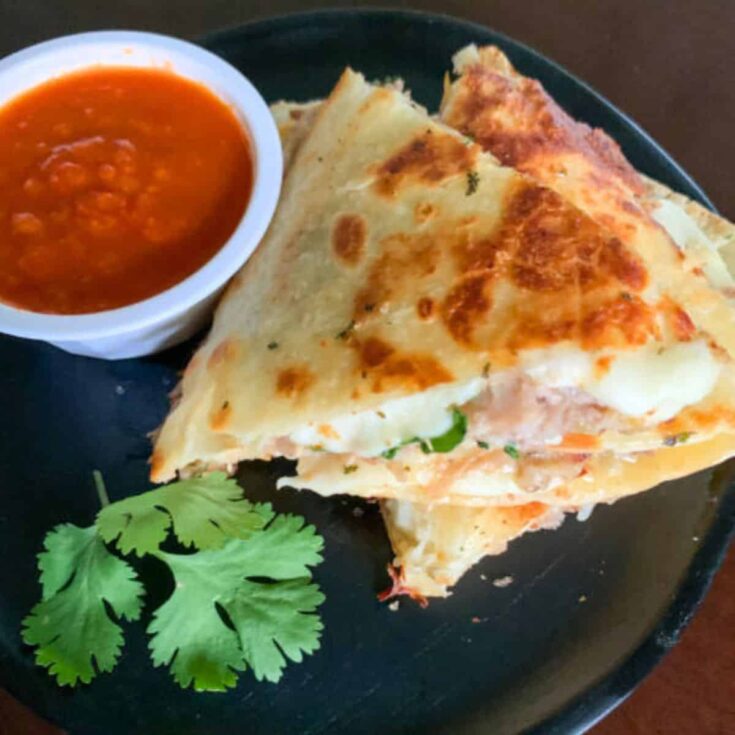 A plate of leftover pulled pork quesadillas with salsa verde