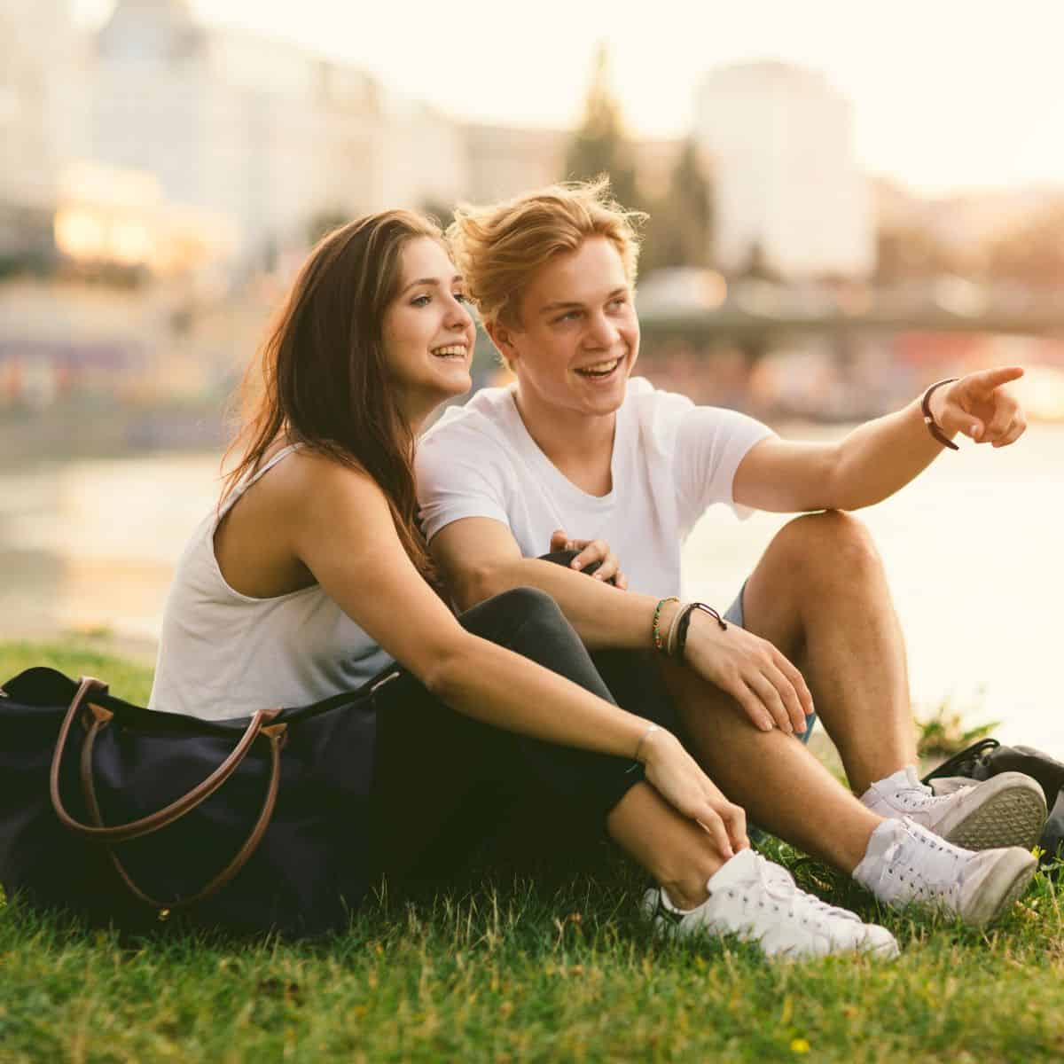 A teenage couple having a date in a park after reading these cheap date ideas for teens