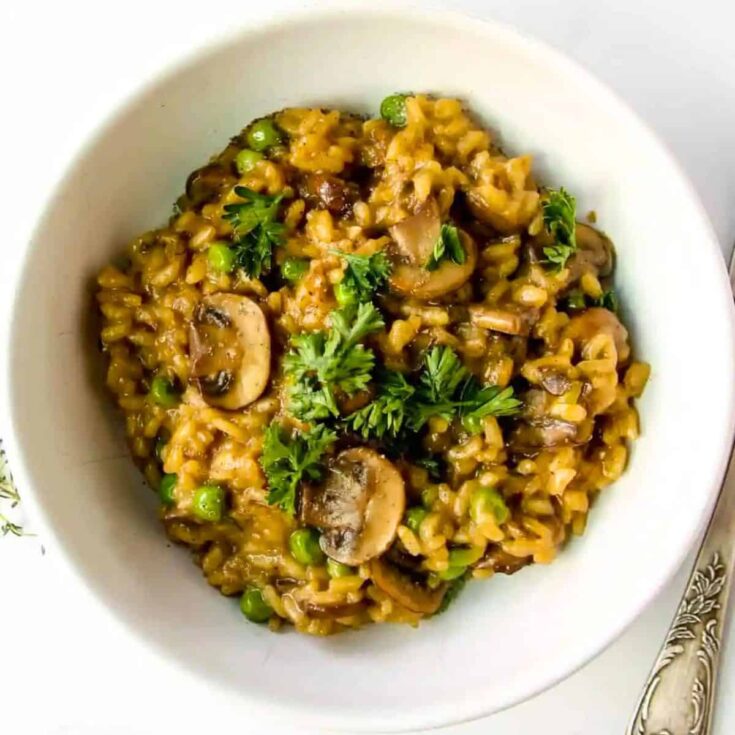 A bowl of mushroom risotto recipe with peas