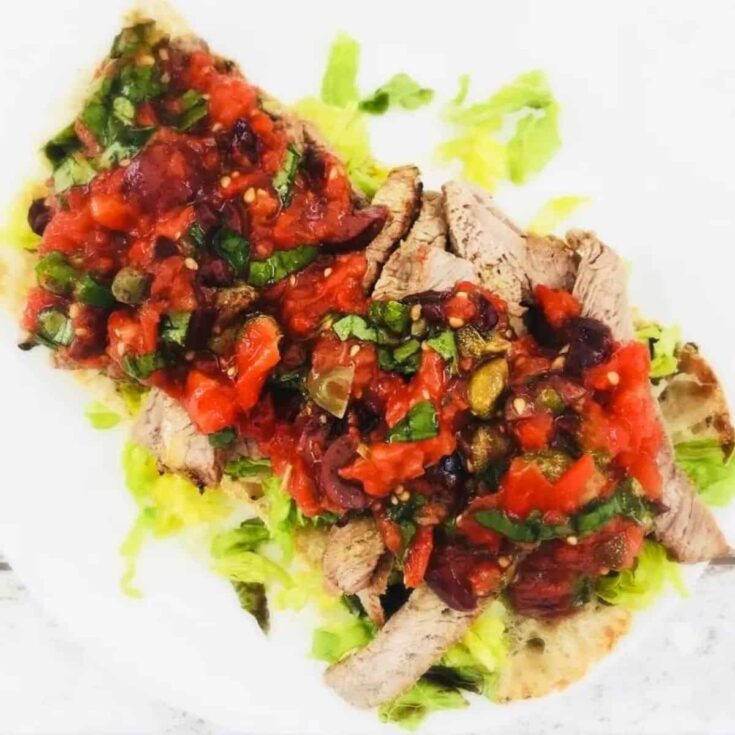 Steak ciabatta with Italian roast tomato salsa on a plate
