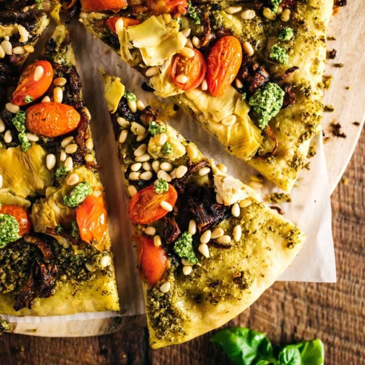 Sliced pesto pizza with fresh tomatoes