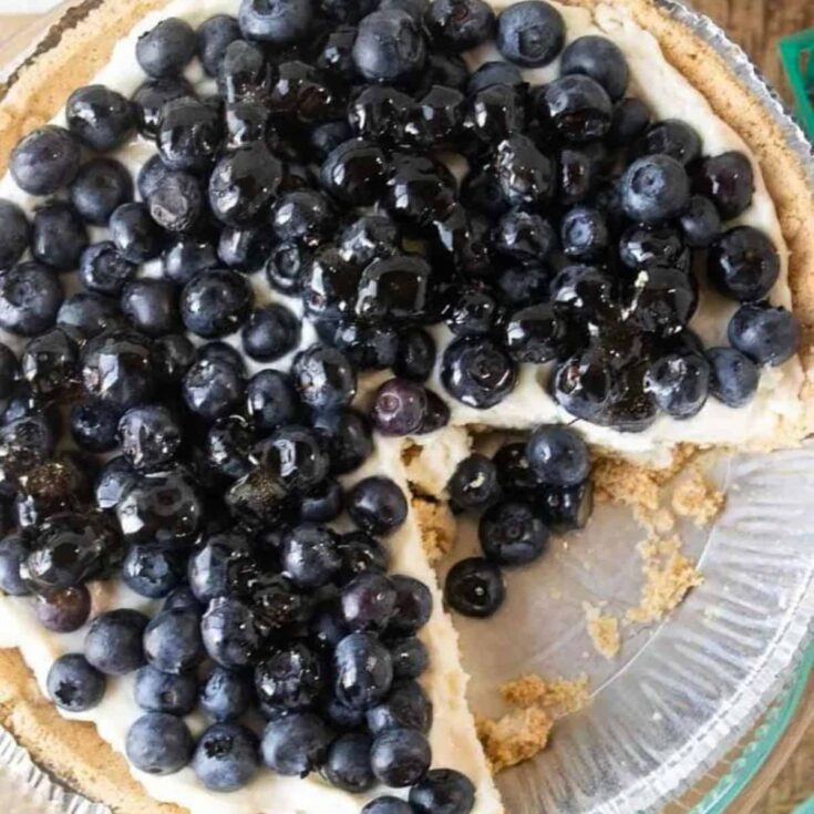 Sliced blueberry cream pie topped with real blueberries