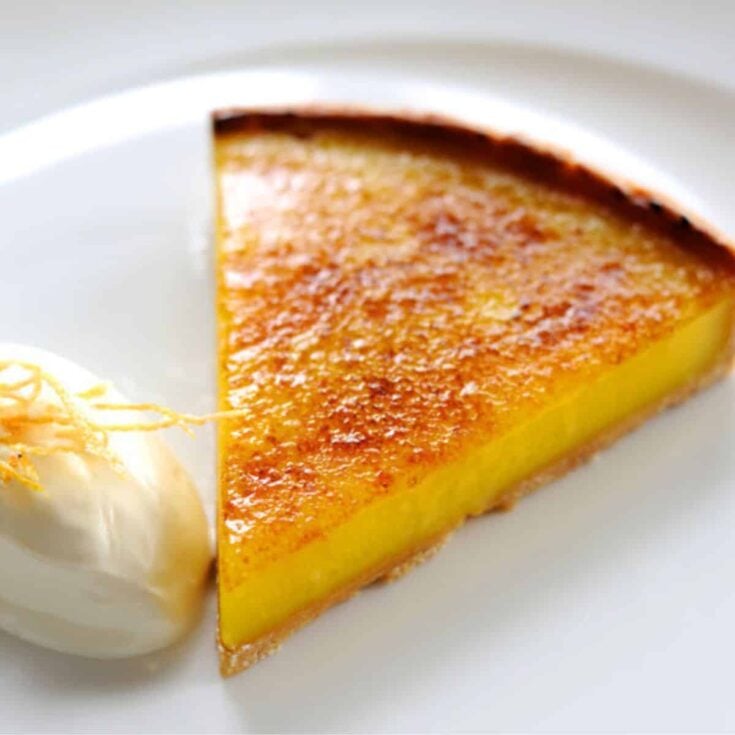 A slice of lemon tart with creme fraiche dessert