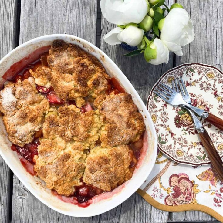 A bowl of rustic summer strawberry rhubarb cobbler