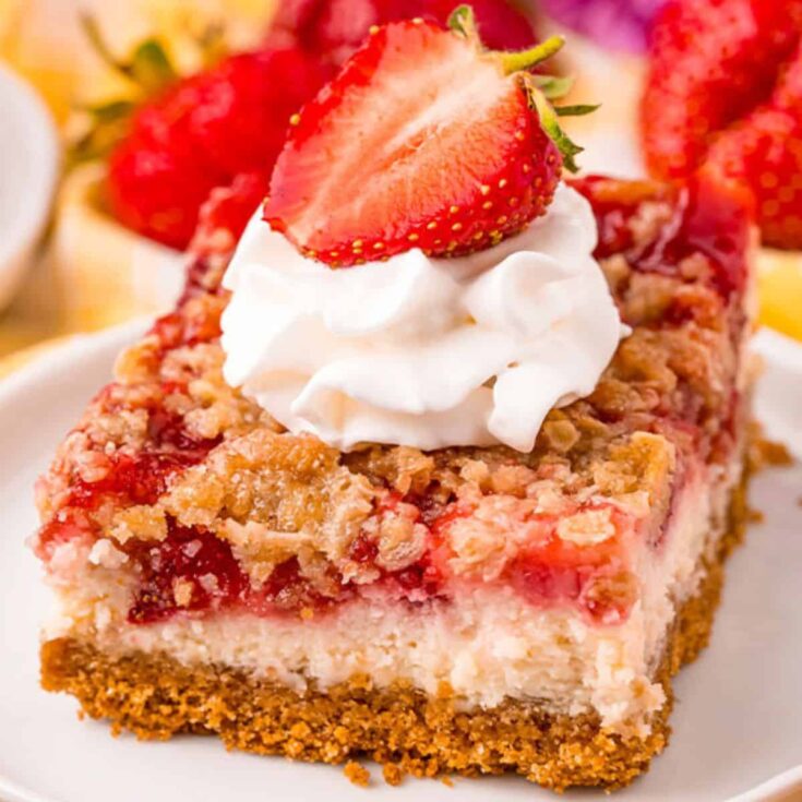 Strawberry cheesecake bars topped with fresh strawberries