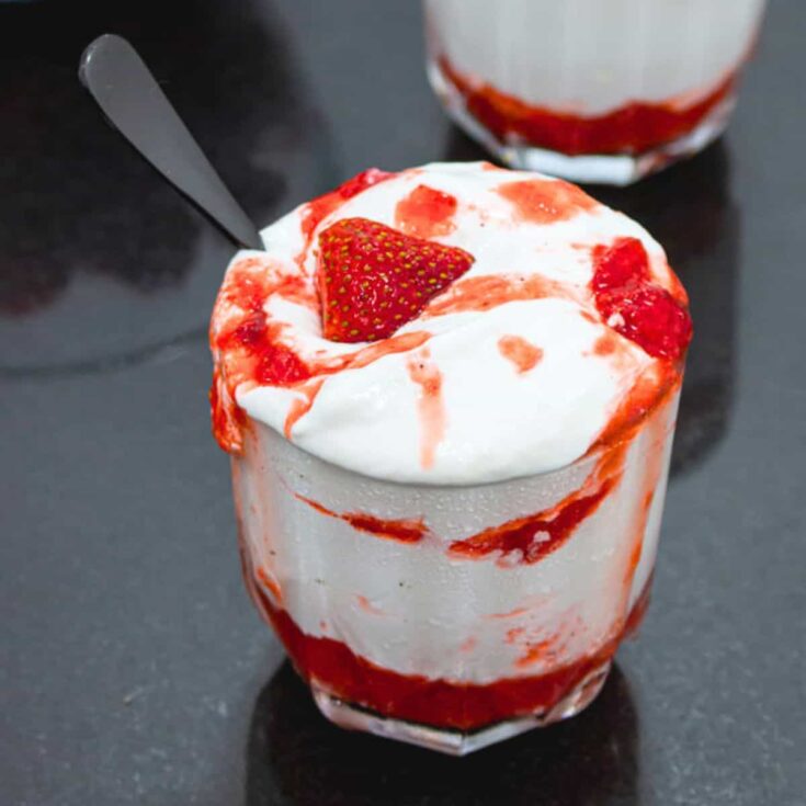 A cup of strawberry fool dessert