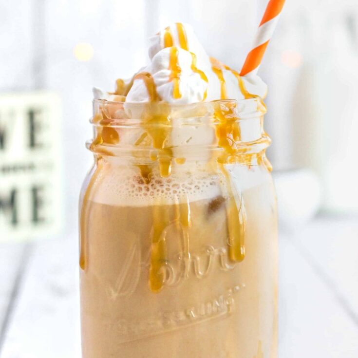 Iced caramel latte topped with whipped cream and caramel drizzle