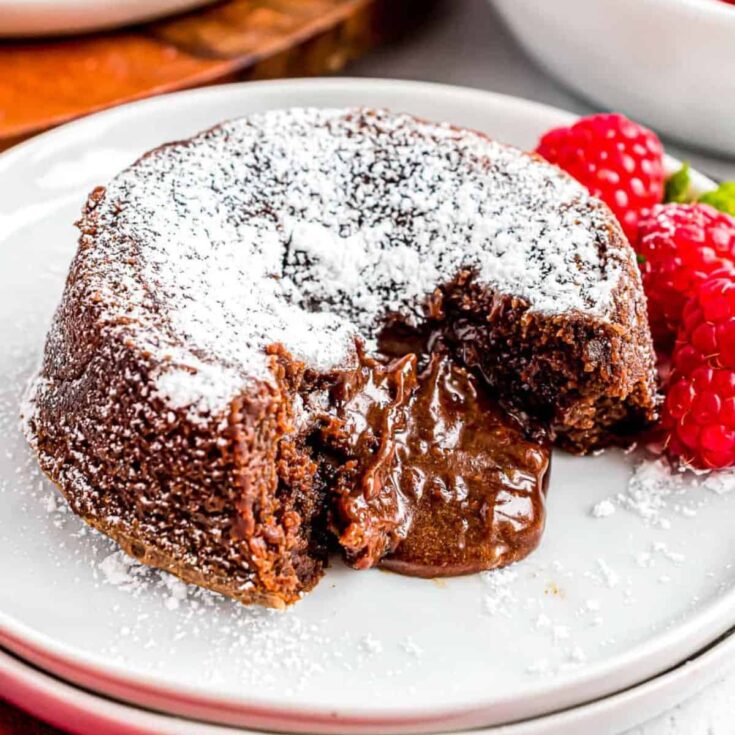 Molten chocolate cake with fresh raspberries on the side
