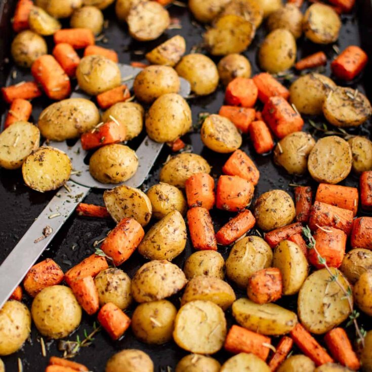 Roasted potatoes and carrots on a tray