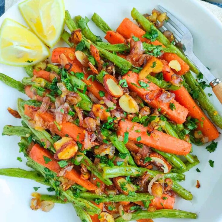 Simple roasted green beans and carrots on a plate