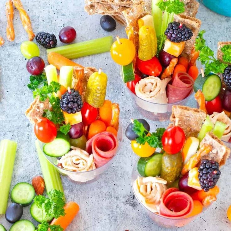 Charcuterie cups filled with fruits, vegetables, and meat