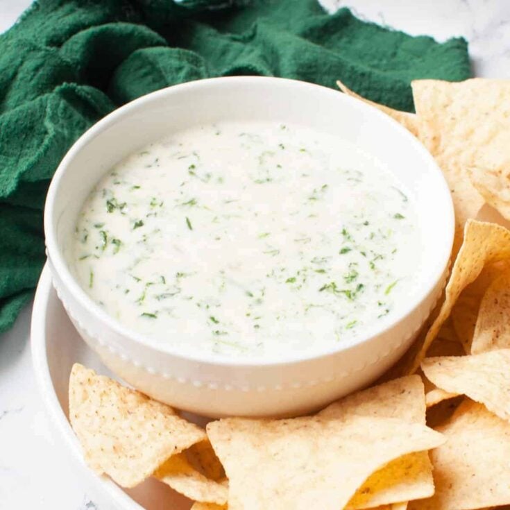 Crockpot spinach queso with chips on the side