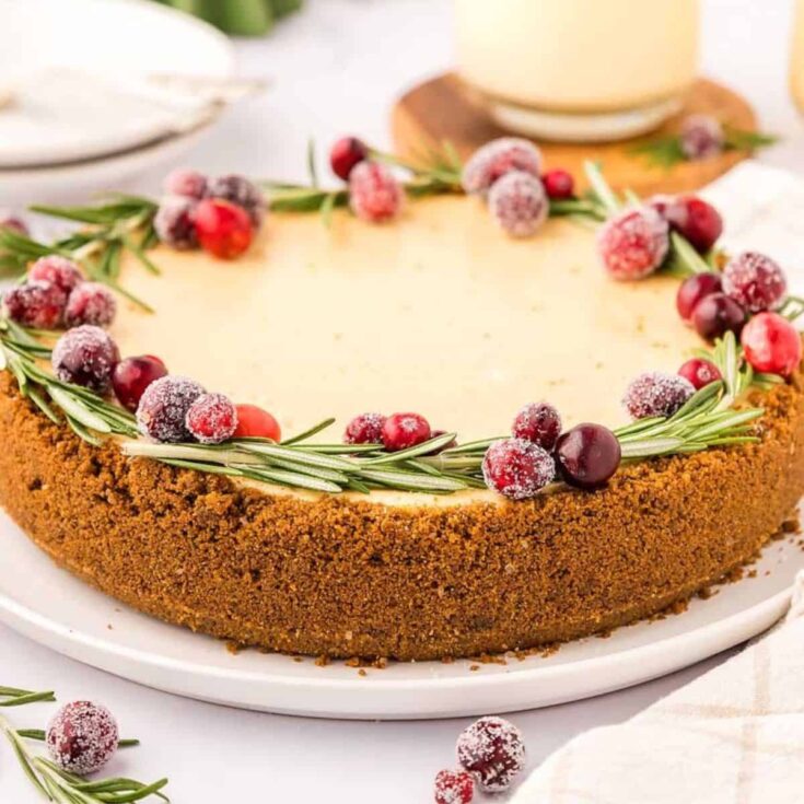Eggnog Christmas cheesecake topped with raspberries and grapes