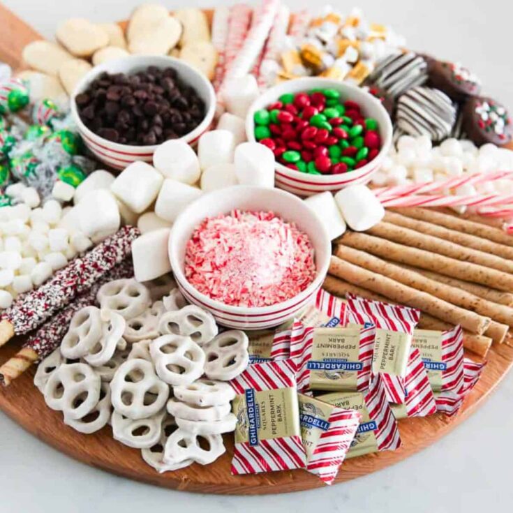 Hot chocolate charcuterie board filled with marshmallows, biscuits, and chocolates