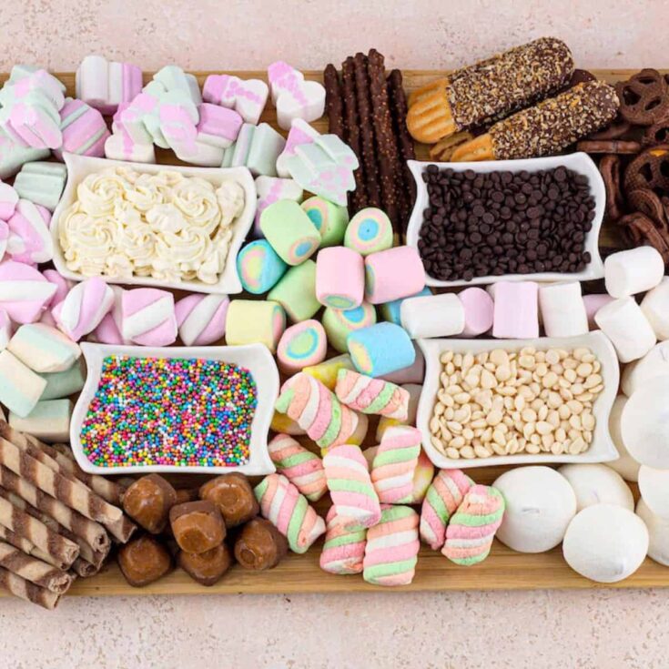 Hot cocoa charcuterie board filled with biscuits, marshmallows, and chocolates