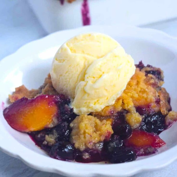 Blueberry peach cobbler topped with vanilla ice cream