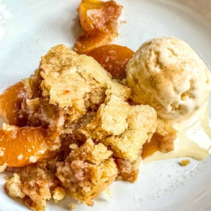 Peach cobbler in a crock pot with cake mix