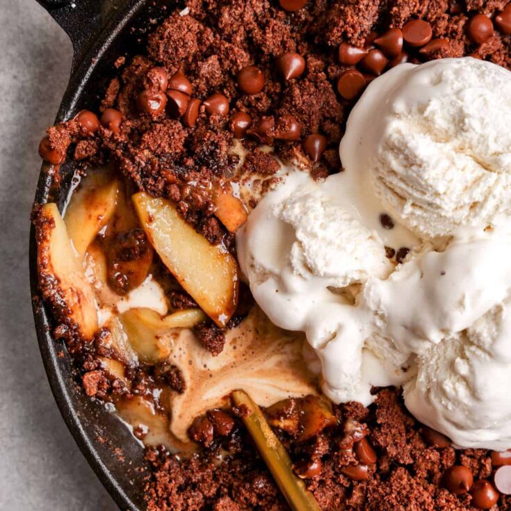 Healthy vegan chocolate apple crisp, topped with vanilla ice cream