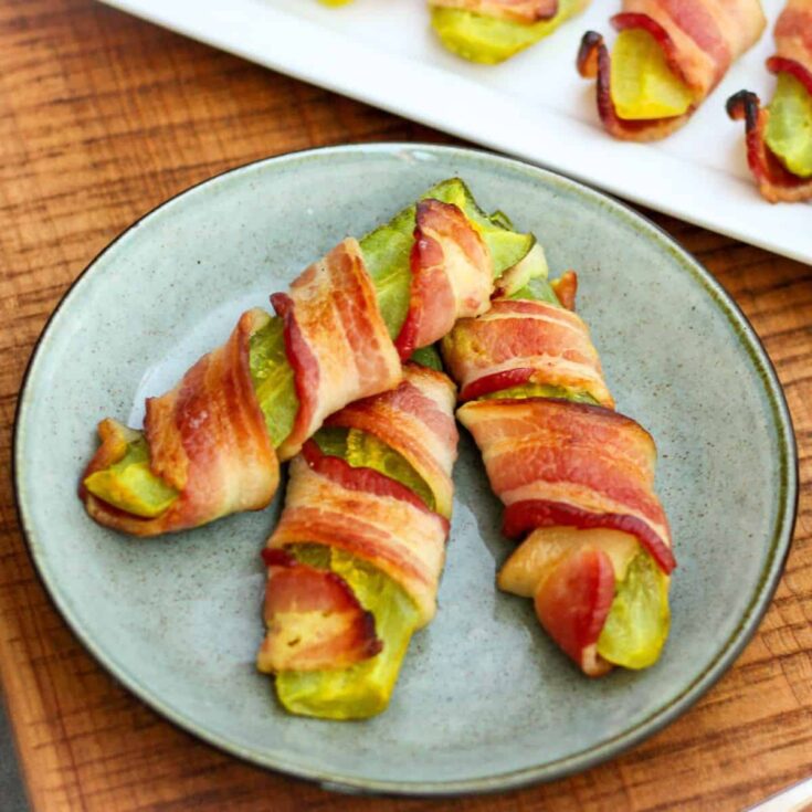 Cast iron bacon wrapped pickles on a plate
