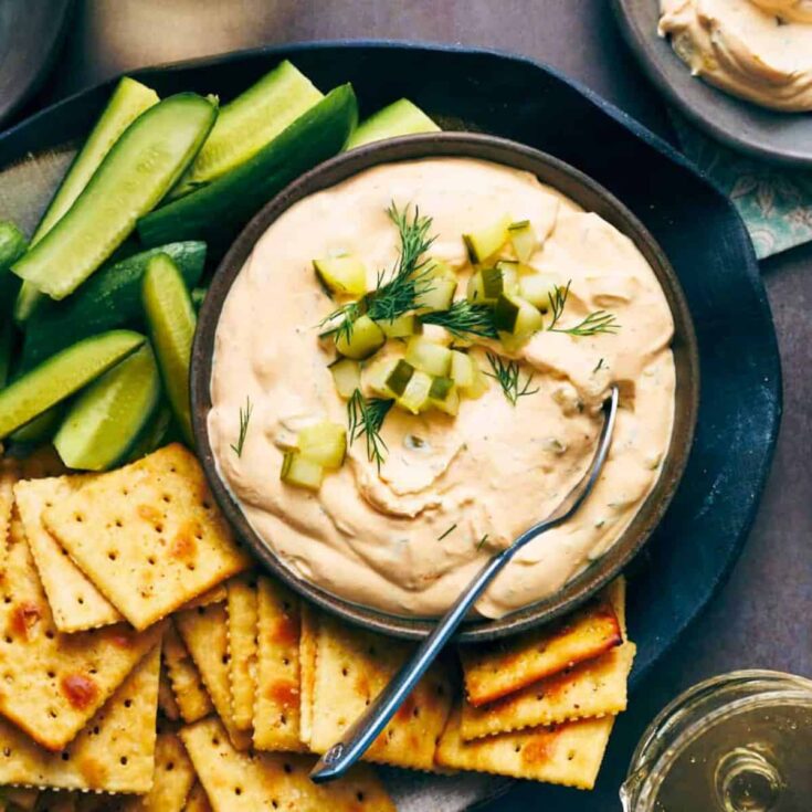 Spicy dill pickle with jalapeno, with cucumber slices and biscuits on the side