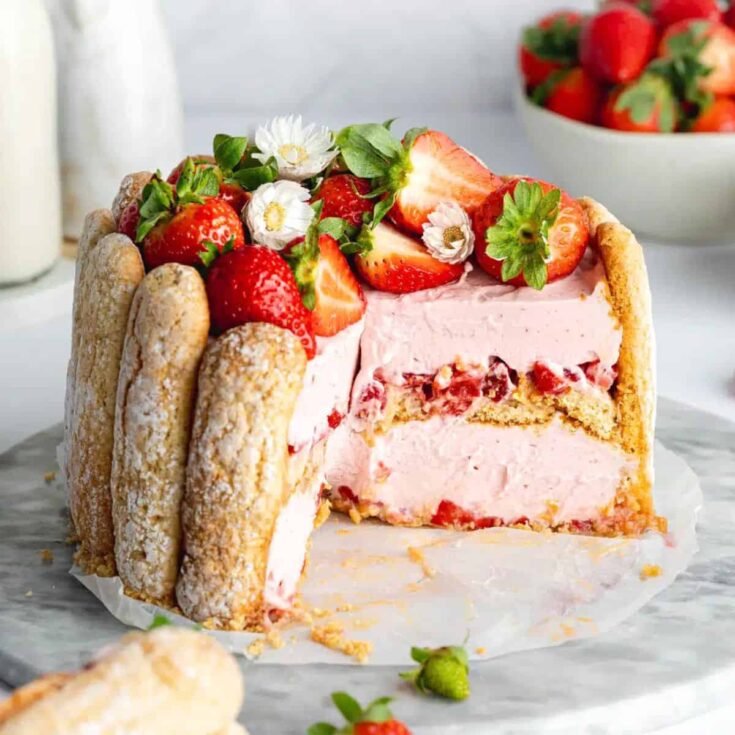 Sliced pink Charlotte aux fraises dessert topped with strawberries